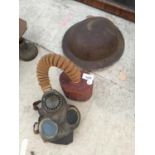 A VINTAGE GAS MASK AND A FURTHER TIN ARMY HELMET