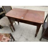 A 19TH CENTURY MAHOGANY FOLD-OVER TEA TABLE ON TURNED LEGS, 36" WIDE