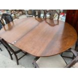 A MAHOGANY EXTENDING DINING TABLE ON TWIN PEDESTAL SUPPORTS WITH SIX SHIELD BACK DINING CHAIRS