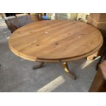 A MODERN CIRCULAR PINE TABLE ON TRIPOD BASE, 54" DIAMETER