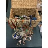 A WICKER LIDDED BASKET CONTAINING A SELECTION OF COSTUME JEWELLERY