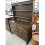 A REPRODUCTION OAK DRESSER, 49" WIDE, WITH FOLIATE DECORATION TO RACK AND FRIEZE