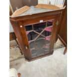 AN OAK CORNER CABINET WITH GLAZED PANEL DOOR