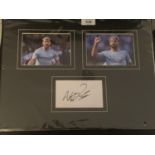 TWO PHOTOGRAPHS OF AGUERO WITH HIS AUTOGRAPH IN A MOUNT COMPLETE WITH A CERTIFICATE OF AUTHENTICITY
