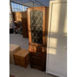 AN OAK CORNER CUPBOARD WITH LOWER DOOR AND UPPER LEAD GLAZED DOOR