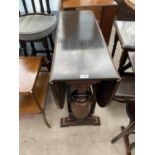 A MAHOGANY DROP LEAF DINING TABLE ON BALUSTER SUPPORTS