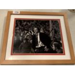 A FRAMED AND SIGNED BLACK AND WHITE PHOTOGRAPH OF WILF MACGUINESS, MANAGER OF MANCHESTER UNITED