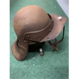 A VINTAGE METAL HELMET WITH FACE GUARD