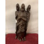 A WOODEN CARVED TRIBAL FIGURE OF THREE ADULTS AND A CHILD