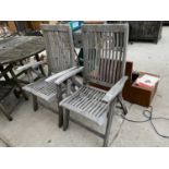 A PAIR OF TEAK GARDEN RECLINING CHAIRS