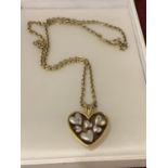 A SILVER MARKED 925 GOLD PLATED CHAIN WITH HEART SHAPED PENDANT ENCOMPASSING SILVER HEART DETAIL,