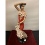 A FIGURINE OF A SPANISH FLAMENCO DANCER