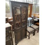 A PRIORY STYLE OAK CORNER CABINET WITH TWO LOWER DOORS AND TWO LEAD GLAZED DOORS