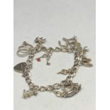 A SILVER CHARM BRACELET WITH TWELVE CHARMS