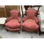 A PAIR OF FRENCH STYLE LOW FIRESIDE CHAIRS