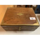 A WOODEN BOX WITH BRASS DETAIL AND HASP
