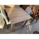 A MODERN SQUARE OAK DINING TABLE AND TWO DINING CHAIRS