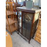 AN OAK CHINA CABINET WITH TWO GLAZED PANEL DOORS AND SIDES