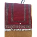 A RED GROUND FRINGED RUG 37 X 57"