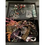 A MODERN DISPLAY CASE CONTAINING AN ASSORTMENT OF COSTUME JEWELLERY