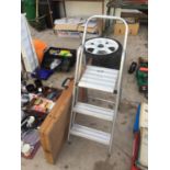 A SMALL STEP LADDER AND A PASTING TABLE