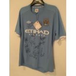 A SIGNED MANCHESTER CITY SHIRT WITH FOURTEEN TEAM SIGNATURES TO INCLUDE JOE HART, SILVA BARRY ETC