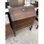 AN OAK BUREAU WITH FALL FRONT AND TWO DRAWERS