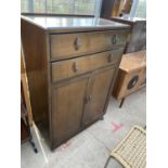 AN OAK TALLBOY WITH TWO DOORS AND TWO DRAWERS