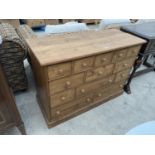 A MODERN PINE CHEST OF THIRTEEN DRAWERS, 47" WIDE