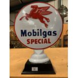 A LARGE CAST METAL ' MOBIL GAS' SIGN ON A BASE