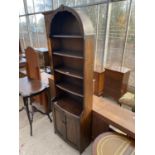 A TALL NARROW OAK DRESSER WITH TWO DOORS AND UPPER SHELVING