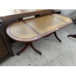 A MAHOGANY COFFEE TABLE ON TWIN PEDESTAL SUPPORTS WITH THREE SECTION LEATHER TOP