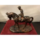 A SPELTER FIGURE OF A JOCKEY ON A RACE HORSE