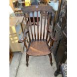 A VICTORIAN HIGH BACKED OAK AND ELM SEATED ARMCHAIR