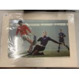 A MOUNTED COLOUR PHOTOGRAPH OF A YOUNG GEORGE BEST AND AN AUTOGRAPH PAT HARRIS COMPLETE WITH