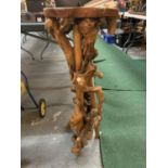 A DECORATIVE CARVED WOODEN PLANT STAND