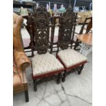 A PAIR OF OAK JACOBEAN STYLE HALL CHAIRS WITH HEAVILY CARVED BACKS AND FRONT RAIL