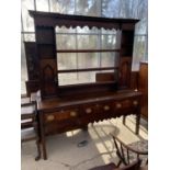 A 19TH CENTURY OAK DRESSER WITH THREE DRAWERS AND UPPER PLATE RACK WITH TWO DOORS