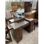 AN OAK DRESSING TABLE WITH SEVEN DRAWERS AND UPPER UNFRAMED MIRROR
