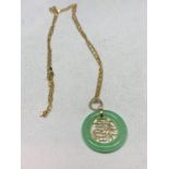 A 9 CARAT GOLD CHAIN WITH A POSSIBLY JADE PENDANT GROSS WEIGHT 9.3g