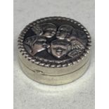A SILVER PILL BOX WITH FACES ON THE LID