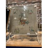 AN ORNATE VINTAGE FIRESCREEN DEPICTING VARIOUS ANIMALS