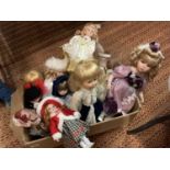 TWELVE ASSORTED PORCELAIN HEADED DOLLS