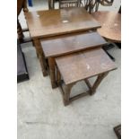 A NEST OF THREE OAK TABLES