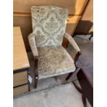 AN OAK FLORAL UPHOLSTERED ARMCHAIR