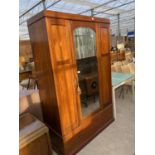 AN INLAID MAHOGANY WARDROBE WITH BEVEL EDGE MIRRORED DOOR AND LOWER DRAWER