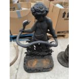 AN ORNATE CAST IRON STICK STAND WITH A BOY AND SNAKE DECORATION