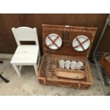 A WICKER PICNIC BASKET WITH CONTENTS AND CHILDS WOODEN CHAIR