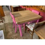 AN OAK DRAW-LEAF DINING TABLE WITH PINK PAINTED BASE, TOGETHER WITH FOUR CHAIRS, TWO PAINTED PINK TO