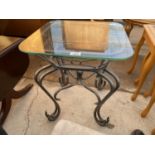 A SMALL WROUGHT IRON OCCASIONAL TABLE WITH GLASS TOP